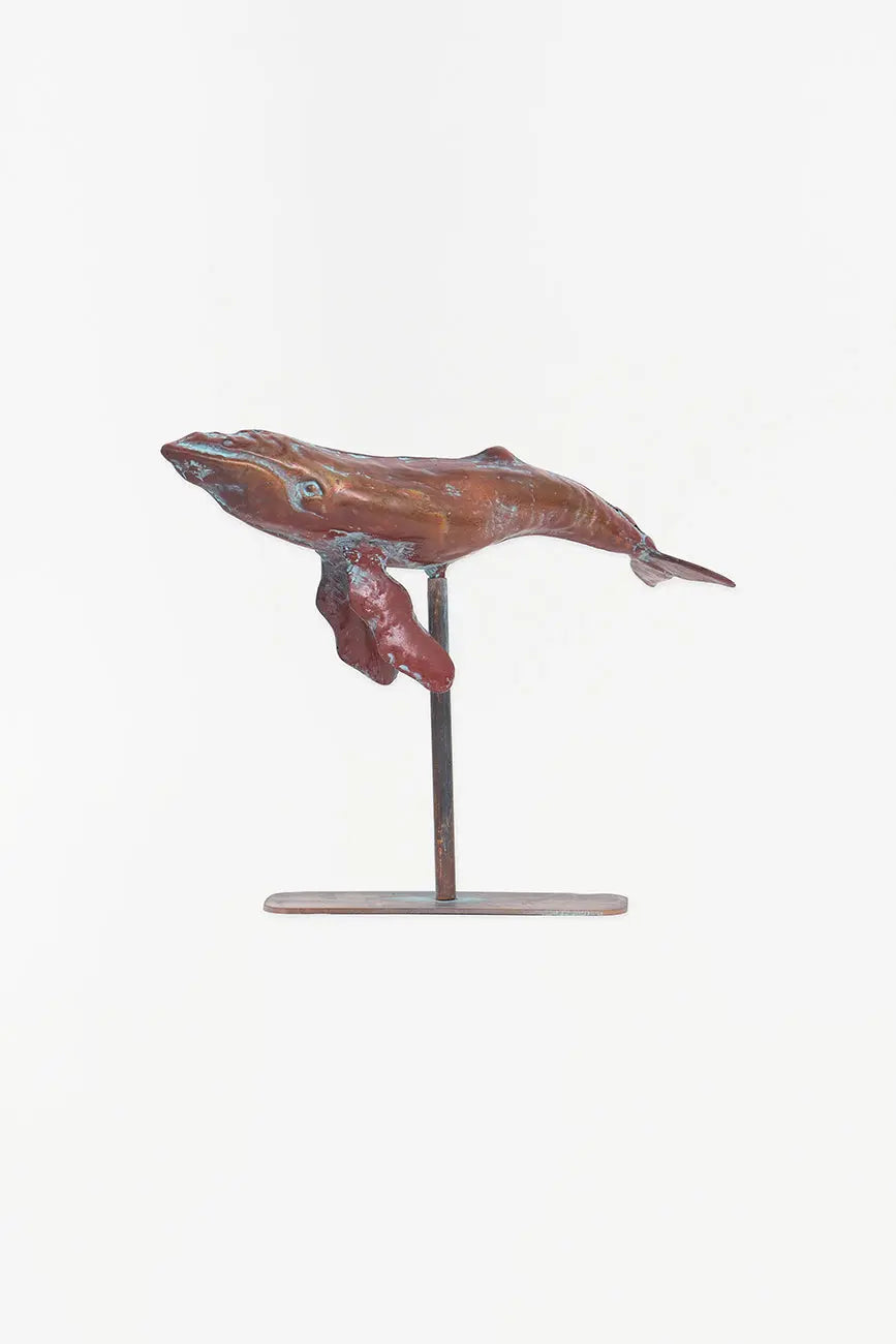 Small decorative humpback whale with a metal base