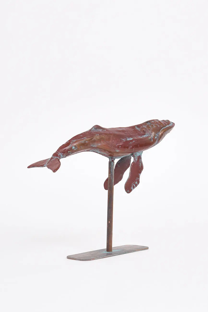 Small decorative humpback whale with a metal base