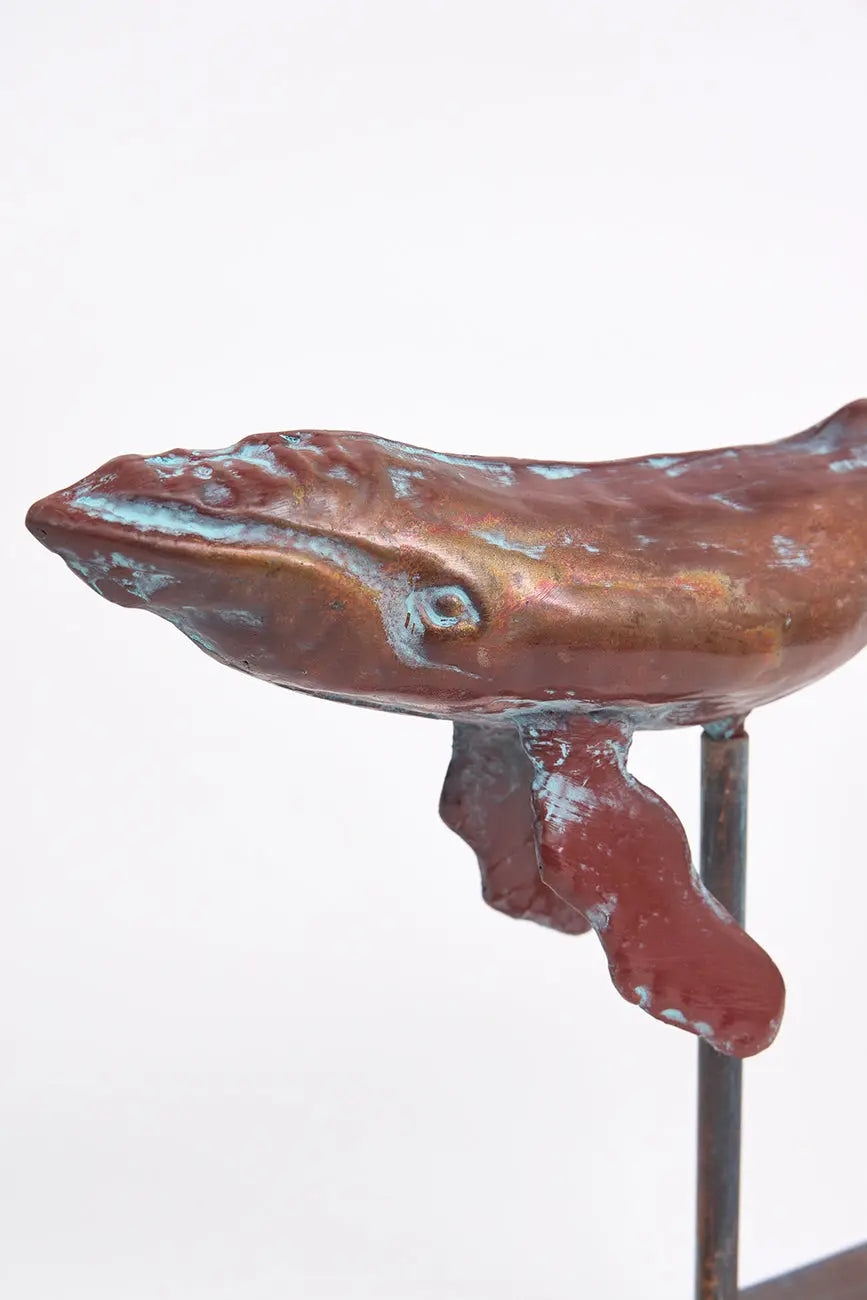 Small decorative humpback whale with a metal base